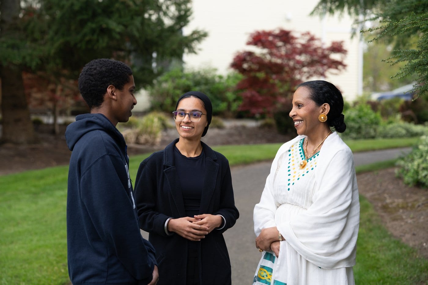 Jasnoor talking with two constituents outdoors